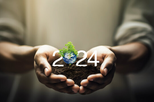 2024 white text with earth and tree on soil in cupped hands, Happy new year 2024 ecological cover, Save the earth concept, Elements of this image furnished by NASA