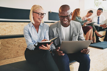 Businesspeople laughing at work
