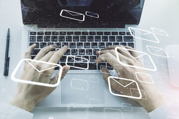 Creative abstract postal envelopes hologram with hands typing on computer keyboard on background,...