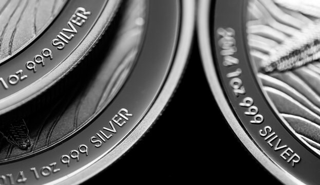 Close up of  Silver Bullion Coin on a black mirror background