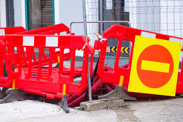 A red plastic construction fence in the city.