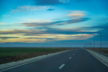 road without traffic with cloudy sky. dramatic sky.