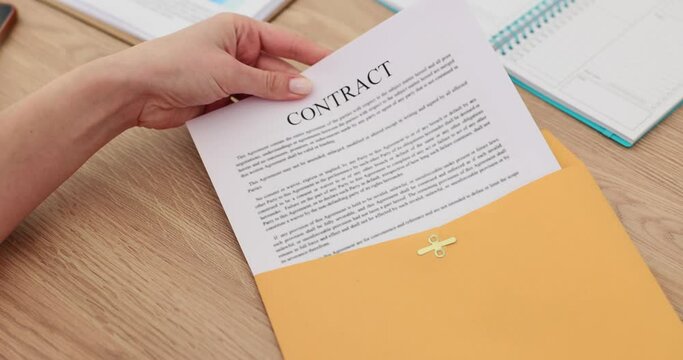 Manager hand taking out paper contract from yellow envelope closeup 4k movie slow motion