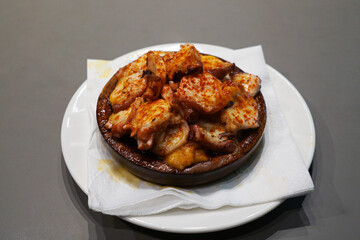 Close up Pulpo a la Gallega or Pulpo a Feira, Galician style steamed octopus in olive oil and paprika powder- Classic Spanish Tapas