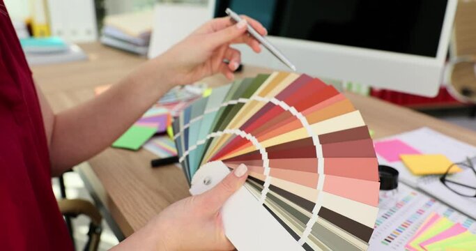 Designer choosing color for decoration in fan with palette 4k movie slow motion
