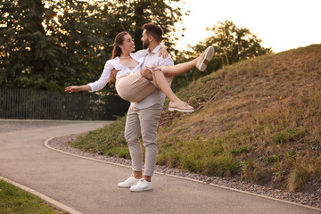 Lovely couple dancing together outdoors at sunset