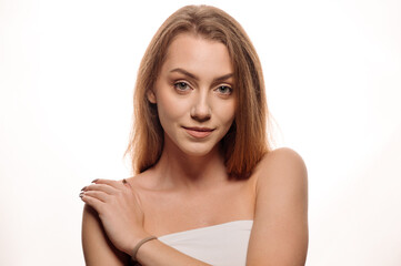 Fototapeta premium Beauty portrait of pretty blonde girl on white isolated background. Skin care concept