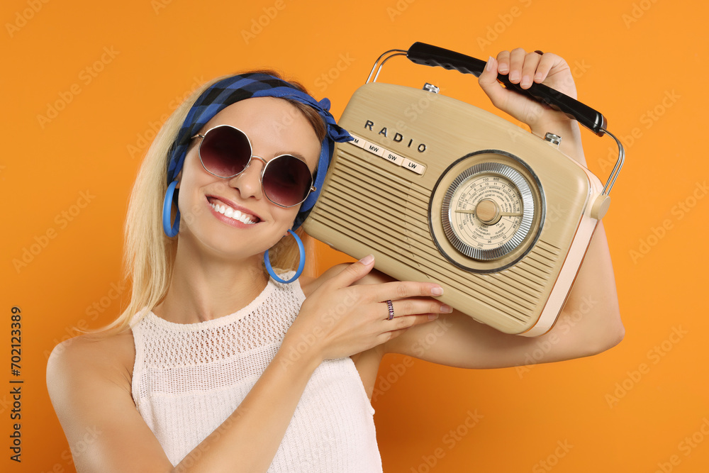 Sticker Happy hippie woman with retro radio receiver on orange background