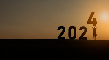 Woman holding standing happy new year 2024 concept, silhouette of woman stand lawn and success with...
