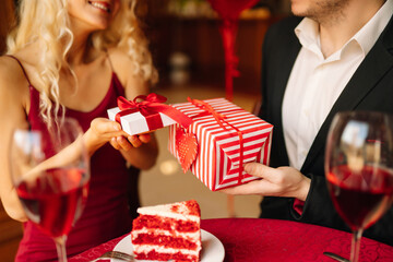 Love, romance, valentine's day. A couple in love in a cafe exchanges gifts and spends time...
