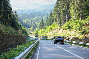 Picturesque view of asphalt road with modern car