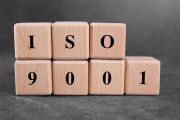 International Organization for Standardization. Cubes with abbreviation ISO 9001 on gray textured...