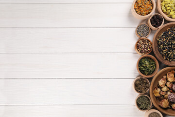 Many different dry herbs and flowers in bowls on white wooden table, flat lay. Space for text