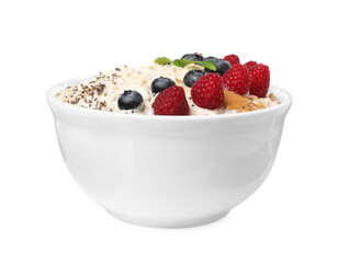 Tasty boiled oatmeal with berries, chia seeds and peanut butter in bowl isolated on white