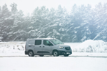 Van driving in the snow. Logistics on a snowy winter day. Delay of cargo delivery due to snowfall...
