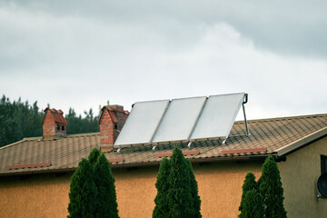The benefits of using solar energy for water heating in a house. solar panels and thermal...