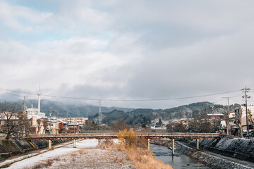 View of Takayama village and miyagawa river with winter snow in Gifu, Japan