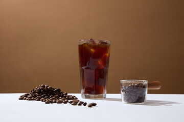 Front view of cup of coffee and coffee beans on brown background. Advertising scene for drink product. Active caffeine in coffee makes you awake, refreshed and work more focused
