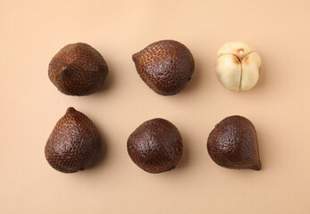 Fresh salak fruits on beige background, flat lay