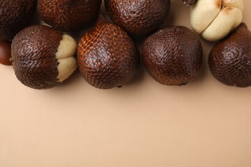 Fresh salak fruits on beige background, top view. Space for text