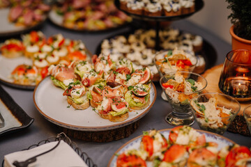 appetizing appetizers presented at a catering event. A variety of dishes are neatly arranged on the buffet table, showcasing a range of colors and textures. - Powered by Adobe