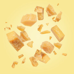 Tasty parmesan cheese falling on light golden background