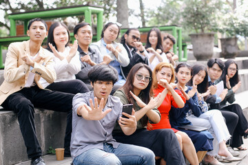 Group of business people sitting outside and showing stop hand gesture