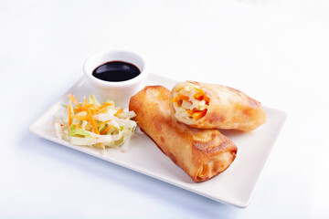 High angle view of spring roll with soy sauce on white background
