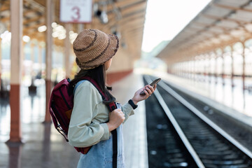 Woman using mobile phone while travel by train. travel concept