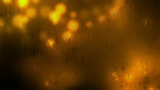 Yellow bokeh background animation seen through a watery and unclean glass
