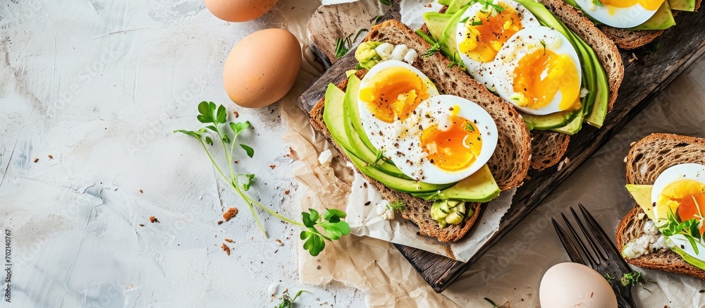 Leinwandbilder a breakfast avocado sandwich with boiled egg. with copy space image. place for adding text or design
