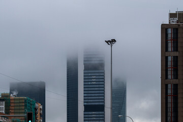 Urban landscape of modern office and apartment buildings on a rainy day in Madrid, Spain