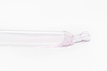 Cosmetic pipette with pink gel, serum, serum on a light background.