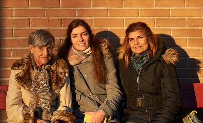 three generations of women grandmother, mother and granddaughter, octogenarian, fifty-something and...