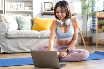 Fototapeta na wymiar Portrait of sport slim fit strength asian woman training in sportswear sitting relax and practicing yoga, fitness, exercise, wellness, workout, sport at home.Diet concept.Fitness and healthy lifestyle