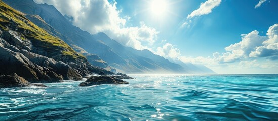 Amazing view of seashore coastline sea waves mountains surrounded by clouds sunlight reflecting on water on sunny day Summer holiday vacation travelling seascape tourism seascape ocean