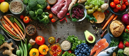  Diet health food concept with a large variety of vegetables fruit meat fish grain salad and spice with foods high in protein antioxidants dietary fibre anthocaynins and vitamins Top view © vxnaghiyev