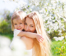 Mother and her little daughter in the spring day