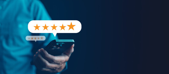 Business people hand using smartphone with popup five star icon for feedback review satisfaction...