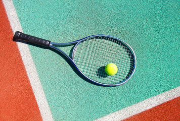 Close up of tennis racquet and ball on the tennis court