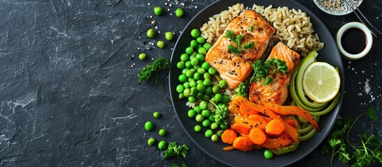 Fried salmon with brown rice peas carrots and leek on a plate. with copy space image. Place for...