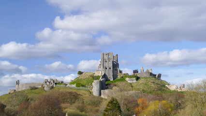 Corfe Castle panorama autumn view, historic ruins of fortification in Dorset, popular tourist landmark, England, United Kingdom