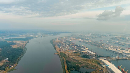 Antwerp, Belgium. River Scheldt (Escaut) port infrastructure with docks and factories. Morning...