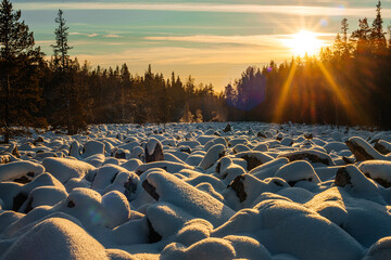 the world's largest stone river in the snow in the rays of the setting sun