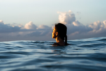 person in the sea during the sunrise