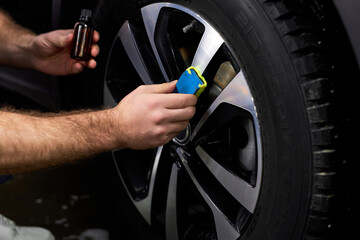 Professional Auto Mechanic Repair Man Using Liquid Oil For Lubricating Car Wheels In Auto Service, Close-up Photo Of Hands