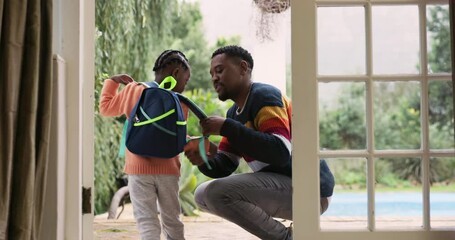 Dad, child and backpack for first school day, help getting ready together at door of home. Love, hug and father with kid, start of kindergarten education with bag and embrace in support and care.