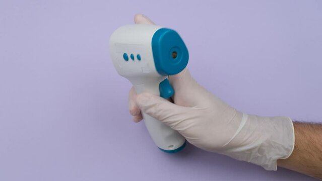 Hand Holding Infrared Thermometer