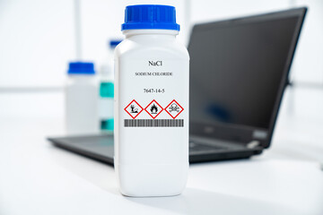 NaCl sodium chloride rock-salt halite CAS 7647-14-5 chemical substance in white plastic laboratory...