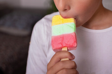 Child's hands hold multi-colored ice cream.Eating ice cream.